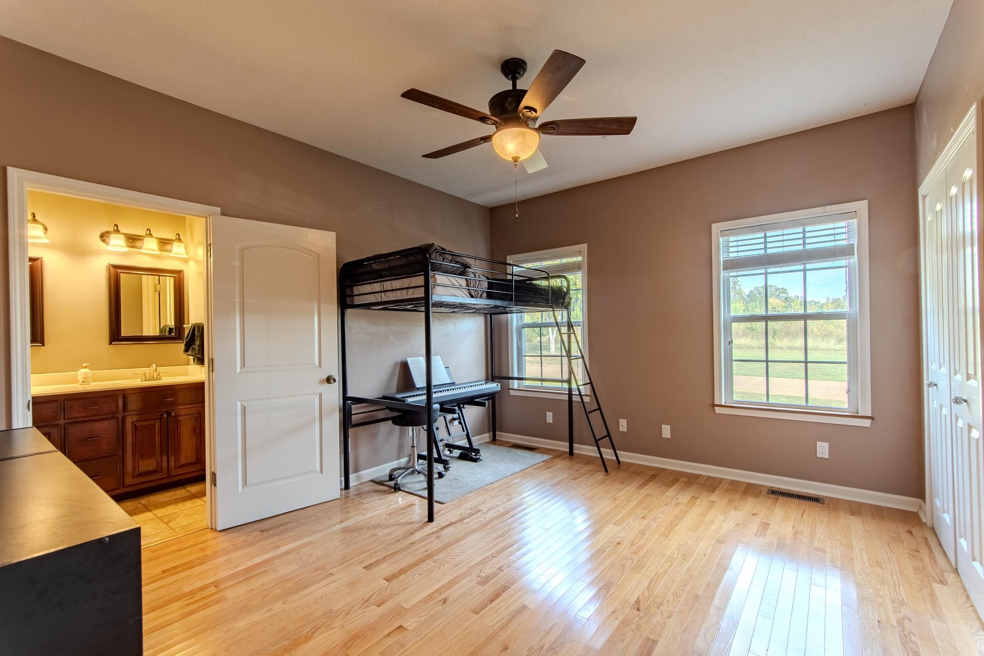 2705 Oak Grove Road Savannah, TN 38372 - Photo 29 of 40 a view of a livingroom with a hardwood floor and a ceiling fan