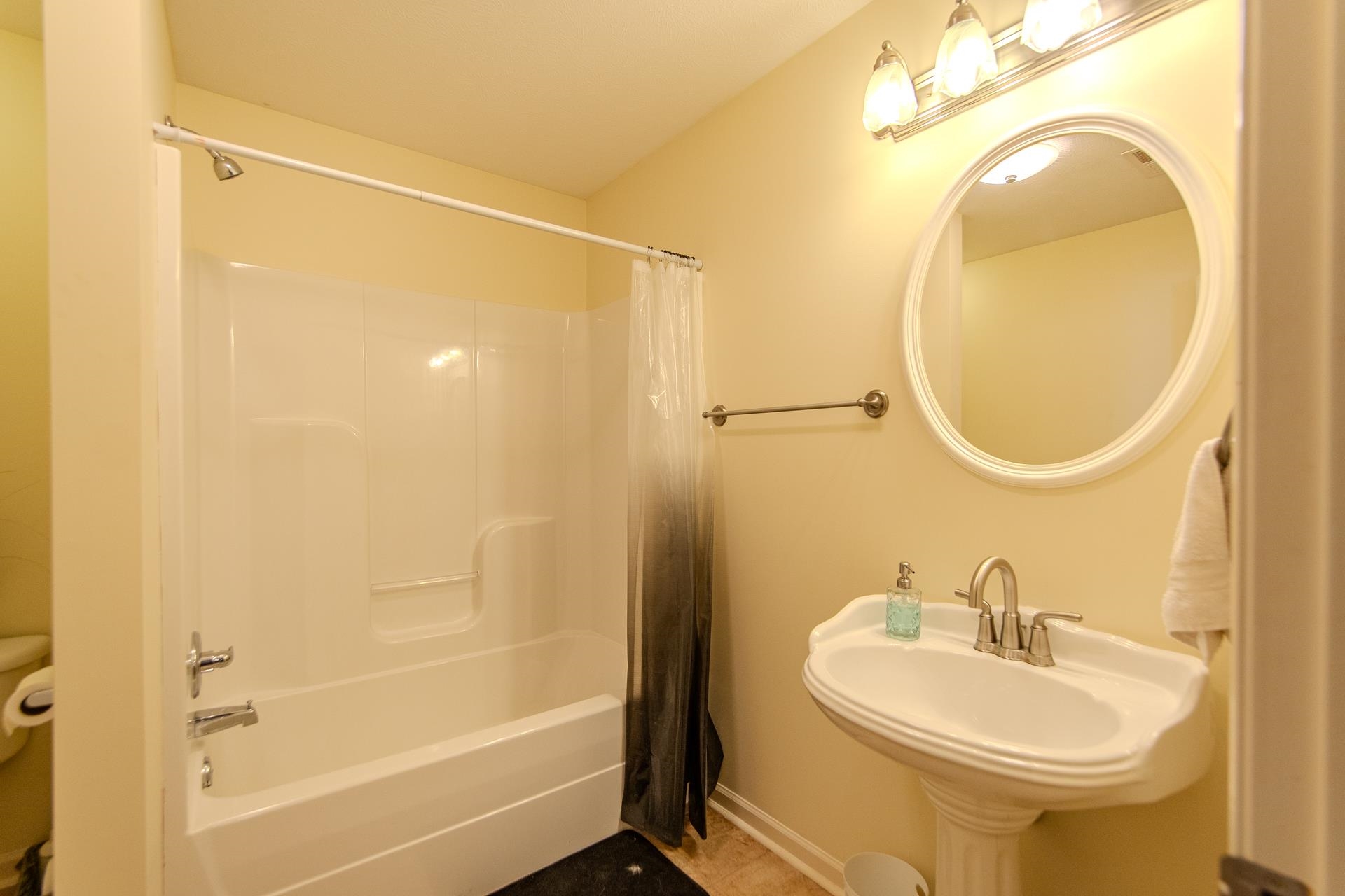2705 Oak Grove Road Savannah, TN 38372 - Photo 34 of 40 a bathroom with a sink a toilet and a mirror