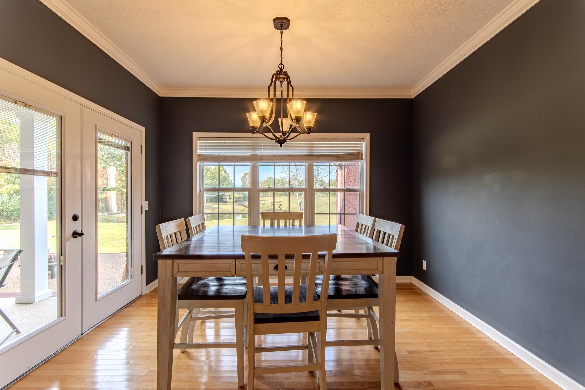 2705 Oak Grove Road Savannah, TN 38372 - Photo 10 of 40 a view of a dining room with furniture a chandelier and wooden floor