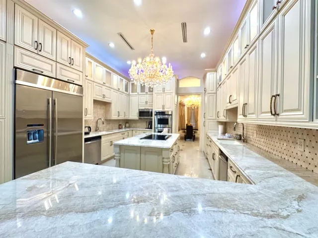 a kitchen with a refrigerator a sink and a stove
