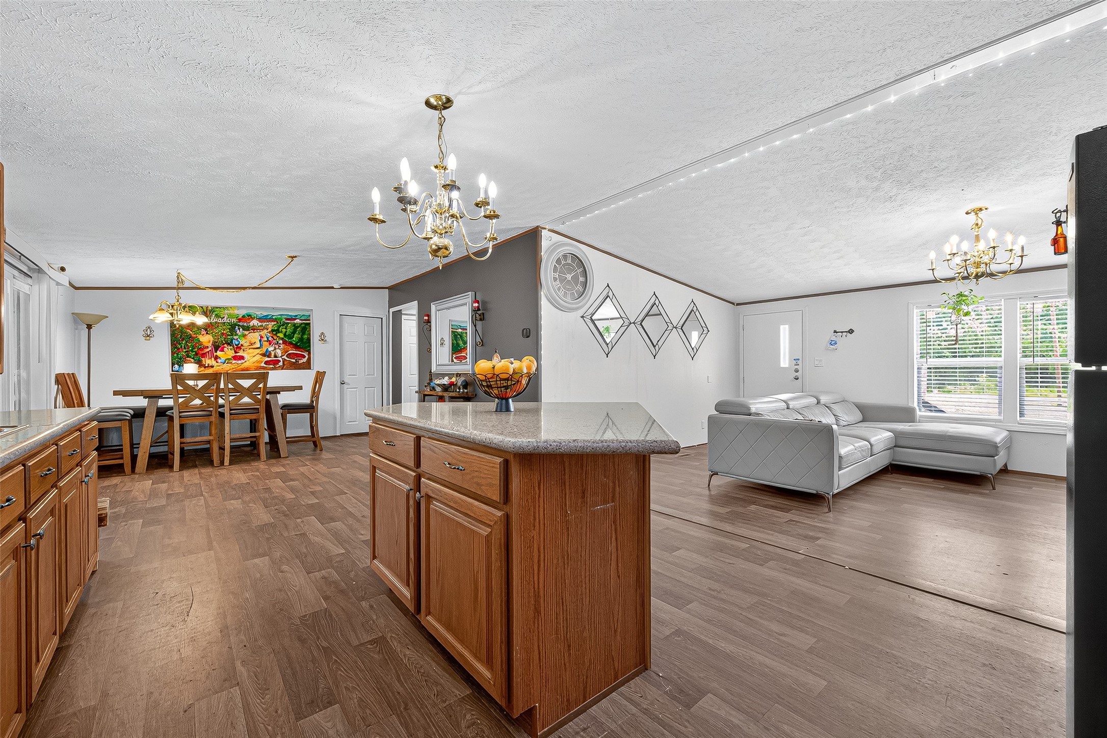 12514 County Road 3740 Cleveland, TX 77327 - Photo 11 of 31 a living room with furniture a dining table and a chandelier