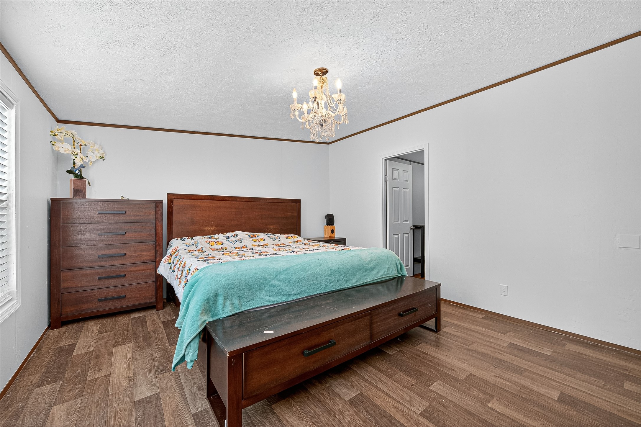 12514 County Road 3740 Cleveland, TX 77327 - Photo 14 of 31 a bedroom with a bed and wooden floor