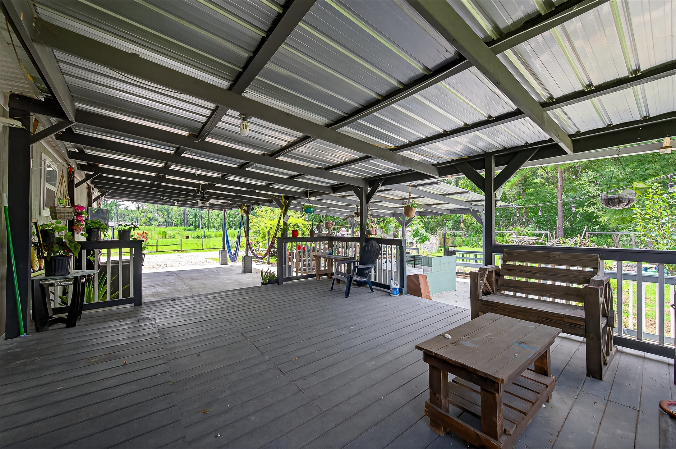 12514 County Road 3740 Cleveland, TX 77327 - Photo 26 of 31 a view of a patio with table and chairs and wooden floor