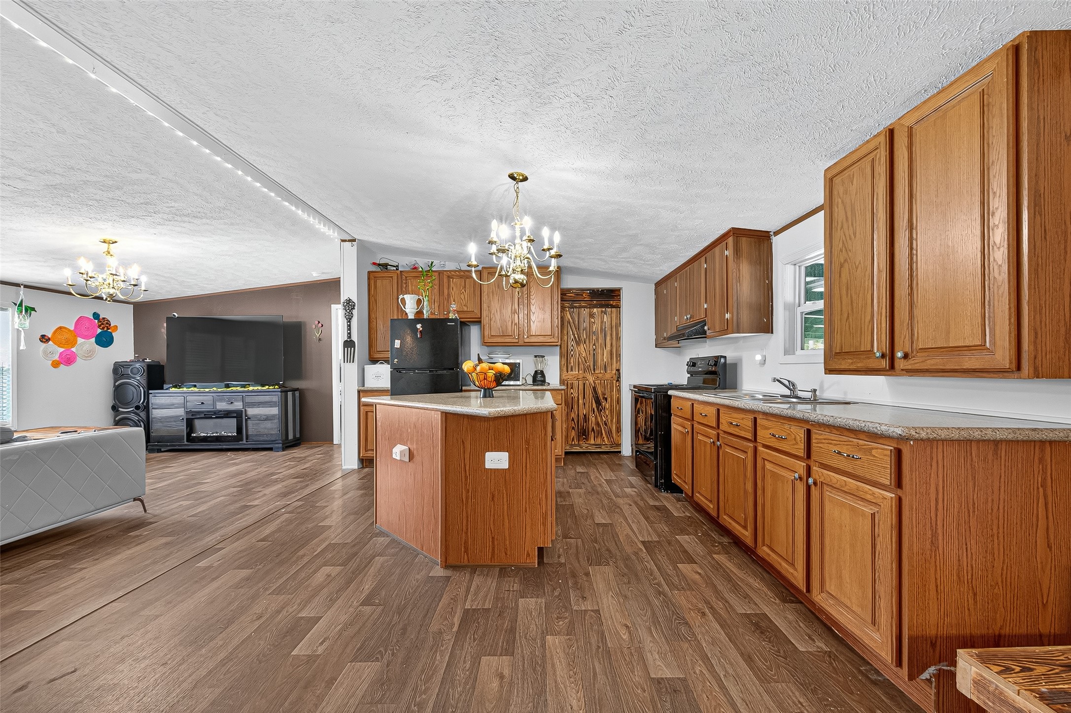 12514 County Road 3740 Cleveland, TX 77327 - Photo 9 of 31 a large kitchen with stainless steel appliances lots of counter space and wooden floor