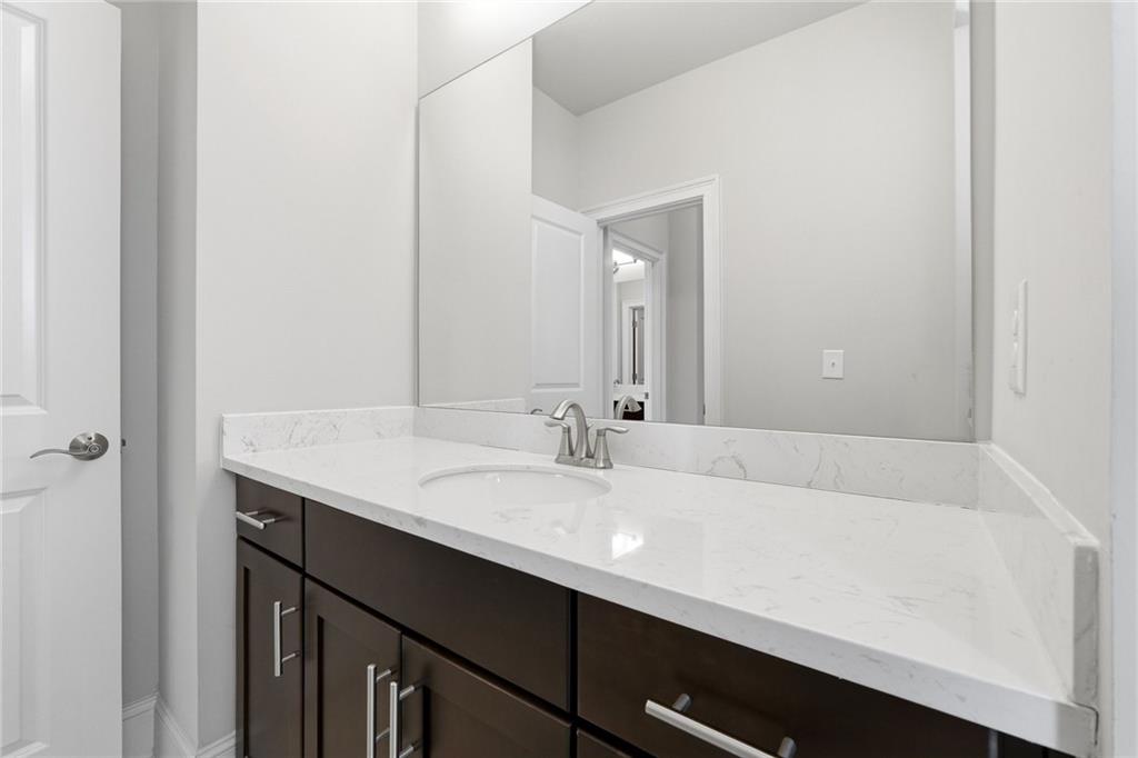 1810 Geranium Lane Cumming, GA 30040 - Photo 12 of 37 a bathroom with a sink and a mirror