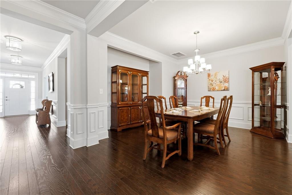 1810 Geranium Lane Cumming, GA 30040 - Photo 13 of 37 a view of a dining room with furniture and wooden floor