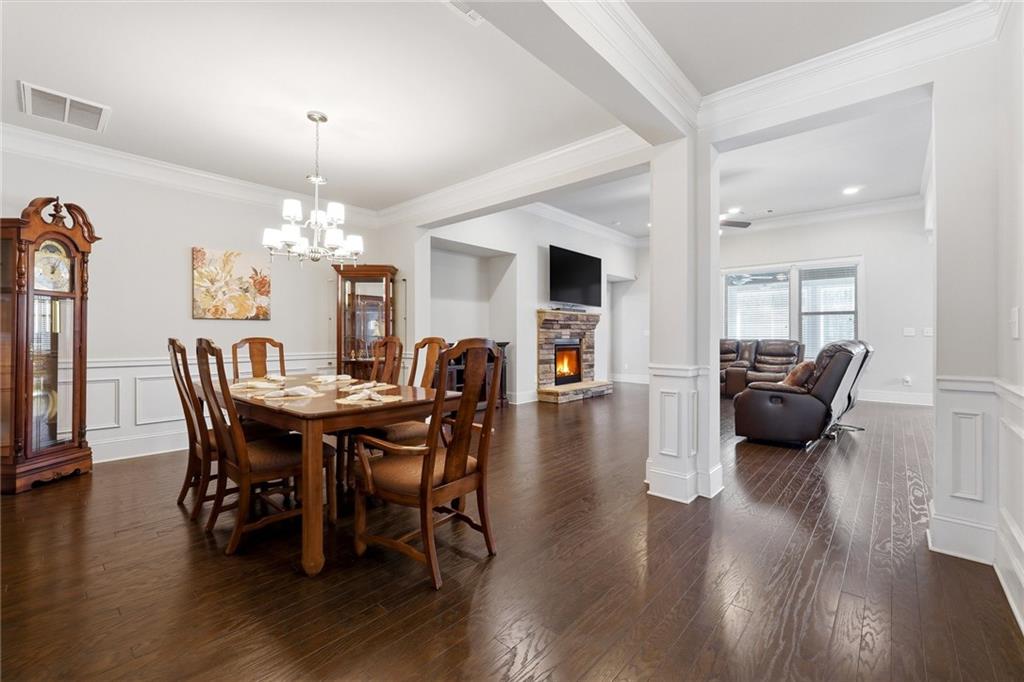 1810 Geranium Lane Cumming, GA 30040 - Photo 14 of 37 a view of a dining room with furniture and wooden floor