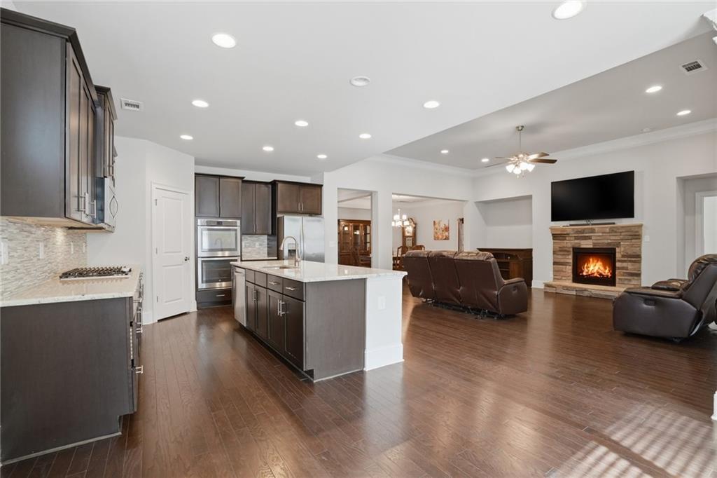 1810 Geranium Lane Cumming, GA 30040 - Photo 19 of 37 a kitchen with furniture a stove and a refrigerator