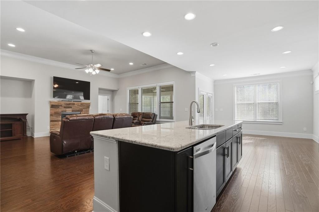 1810 Geranium Lane Cumming, GA 30040 - Photo 21 of 37 a large kitchen with stainless steel appliances a large counter top and a wooden floors