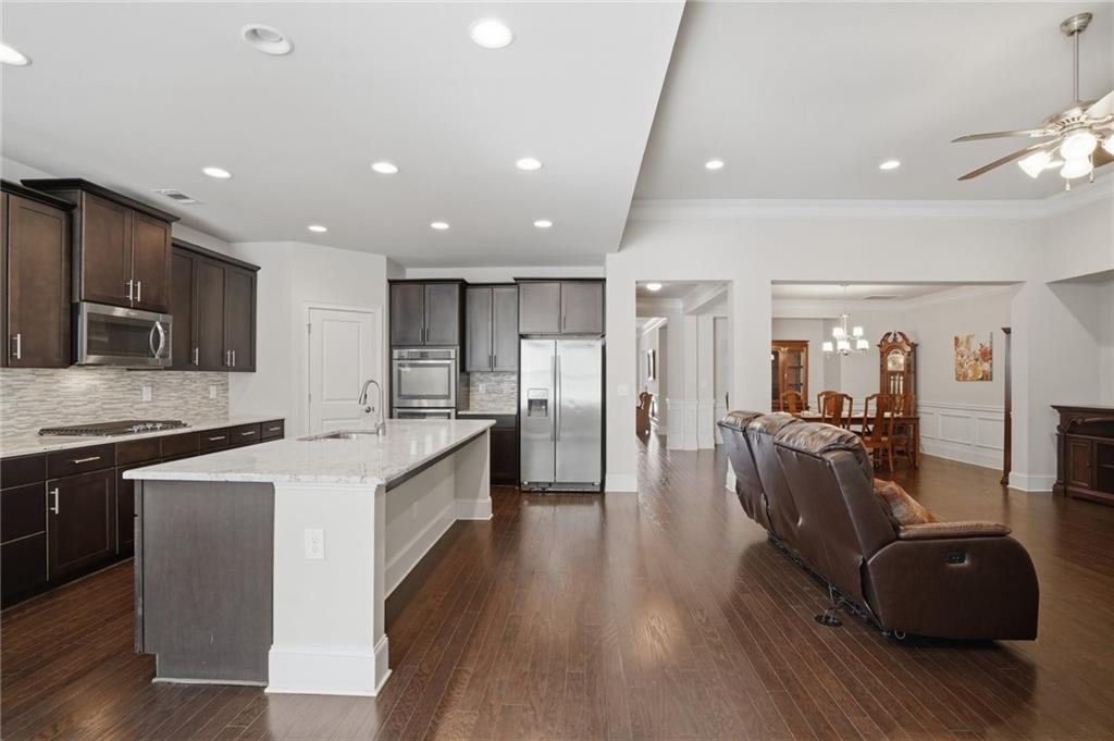 1810 Geranium Lane Cumming, GA 30040 - Photo 22 of 37 a large kitchen with stainless steel appliances lots of counter space and wooden floor