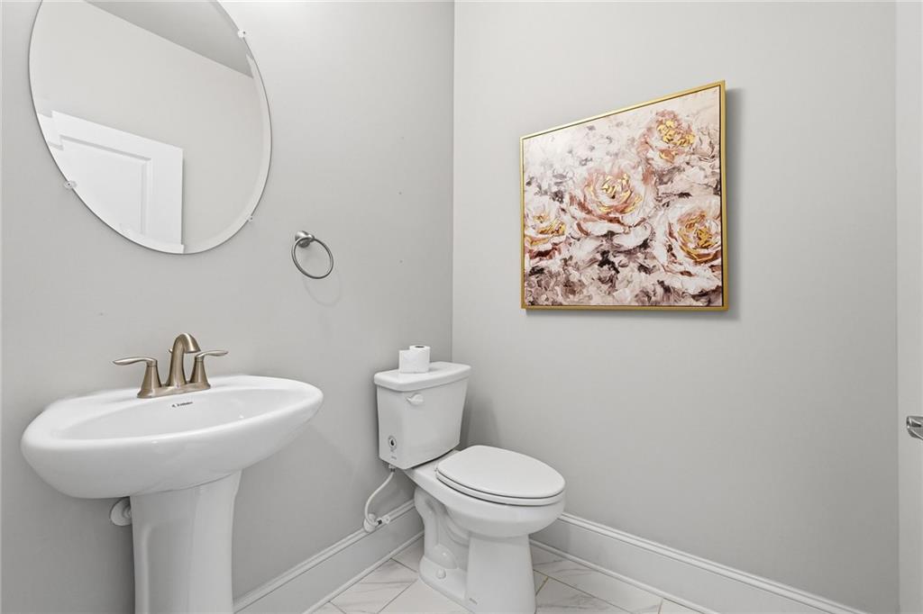 1810 Geranium Lane Cumming, GA 30040 - Photo 24 of 37 a bathroom with a toilet a sink and mirror