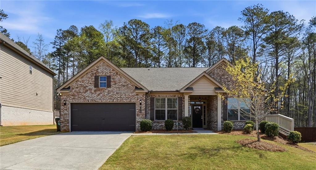 1810 Geranium Lane Cumming, GA 30040 - Photo 34 of 37 a front view of a house with a yard and garage