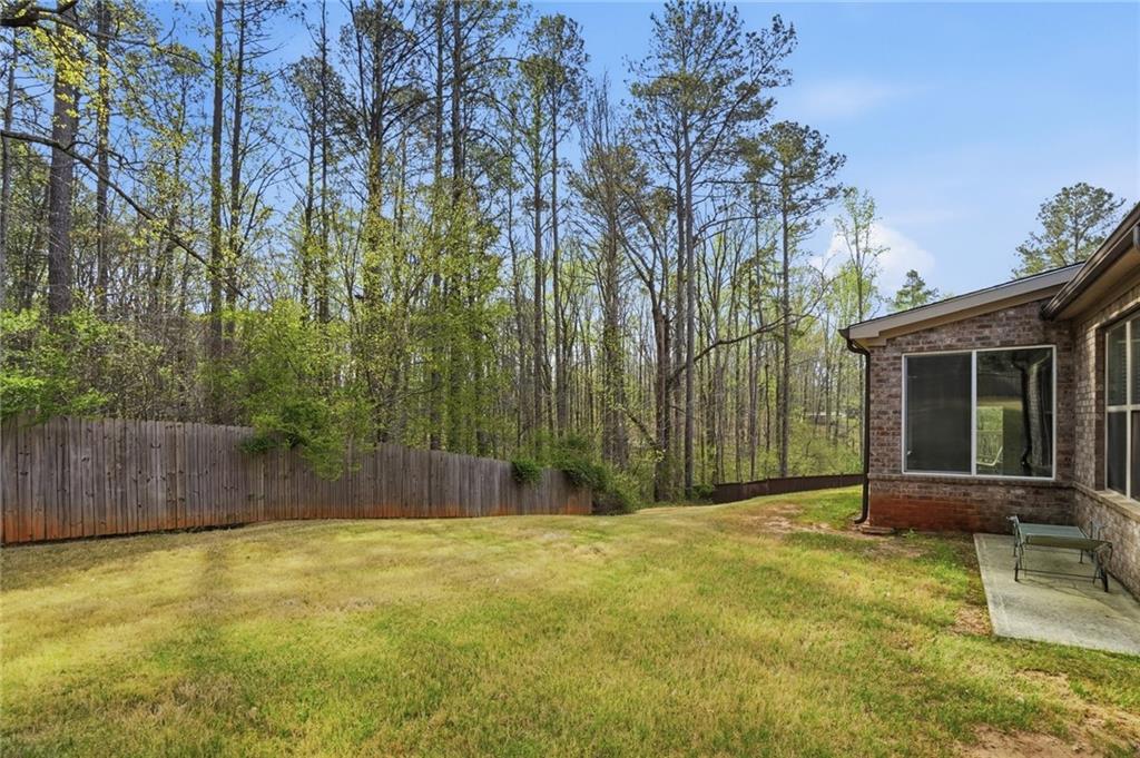 1810 Geranium Lane Cumming, GA 30040 - Photo 35 of 37 a backyard of a house with table and chairs