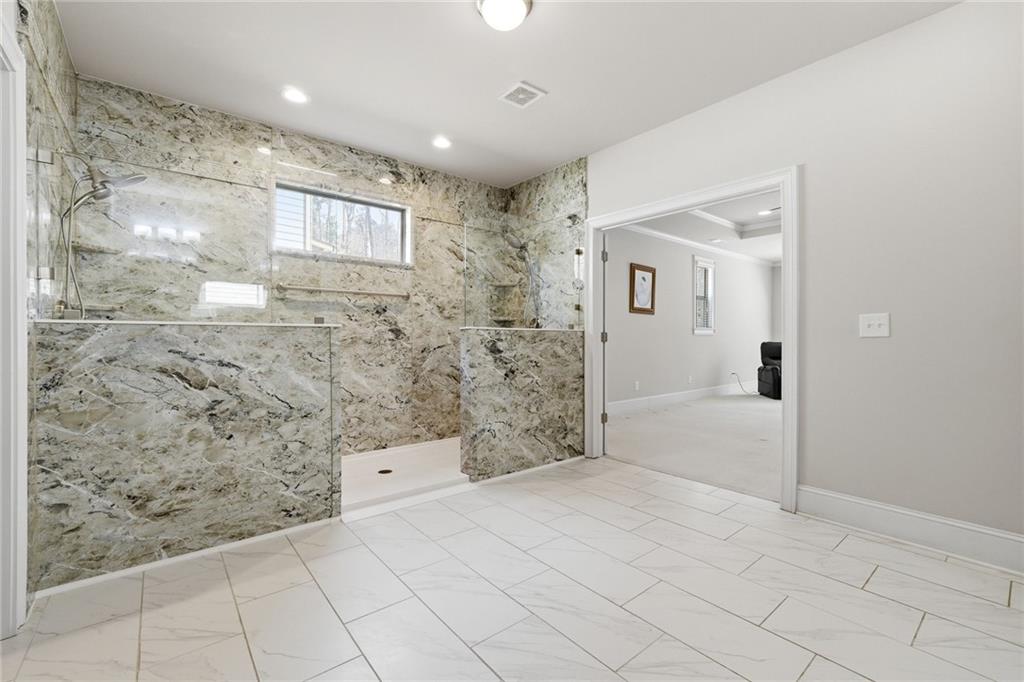 1810 Geranium Lane Cumming, GA 30040 - Photo 4 of 37 a bathroom with a glass door shower
