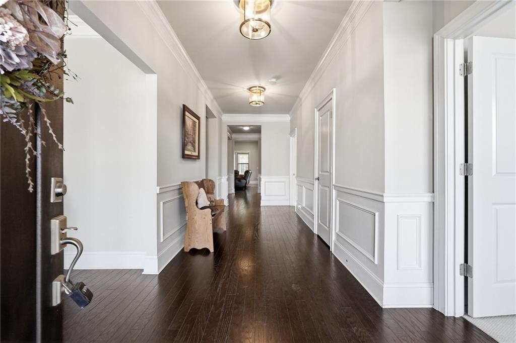 1810 Geranium Lane Cumming, GA 30040 - Photo 6 of 37 a view of a hallway with wooden floor and stairs