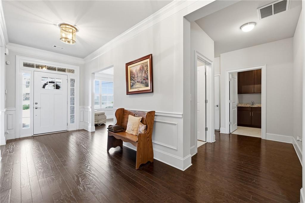 1810 Geranium Lane Cumming, GA 30040 - Photo 7 of 37 a view of a livingroom with wooden floor and furniture