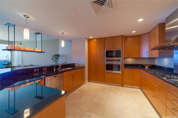 a kitchen with stainless steel appliances granite countertop a sink and cabinets