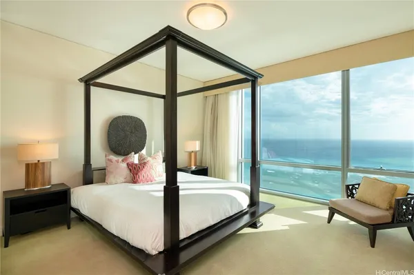 a bedroom with a bed and a large window