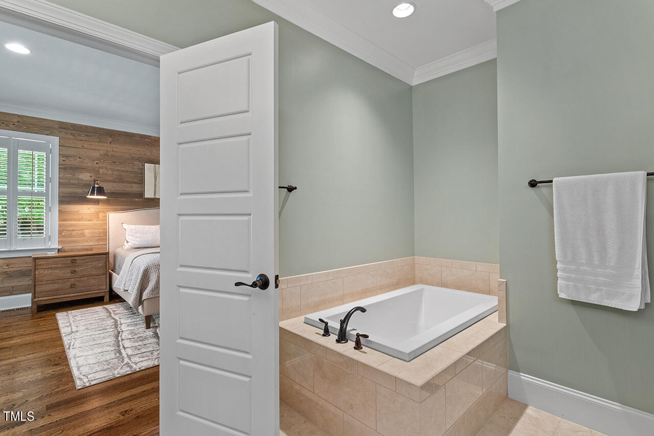 2016 Brassfield Road Raleigh, NC 27614 - Photo 20 of 44 a bathroom with a tub a sink and a window