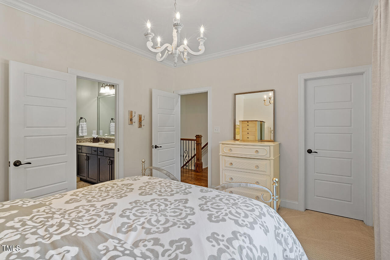 2016 Brassfield Road Raleigh, NC 27614 - Photo 25 of 44 a bedroom with a bed and a dresser in it