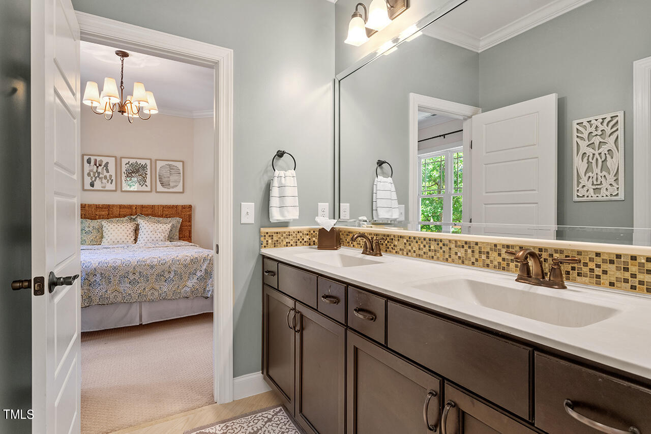 2016 Brassfield Road Raleigh, NC 27614 - Photo 26 of 44 a en suite bathroom with a double vanity sink and a mirror