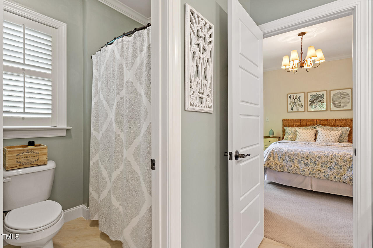 2016 Brassfield Road Raleigh, NC 27614 - Photo 27 of 44 a bedroom with a bed and a mirror