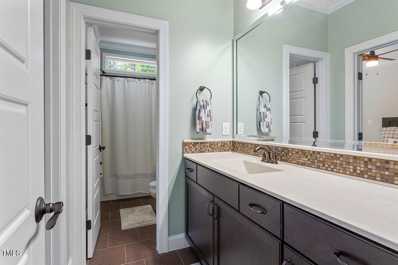 2016 Brassfield Road Raleigh, NC 27614 - Photo 29 of 44 a bathroom with a granite countertop sink and a mirror