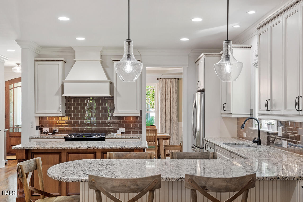 2016 Brassfield Road Raleigh, NC 27614 - Photo 6 of 44 a kitchen with granite countertop a table chairs sink and cabinets