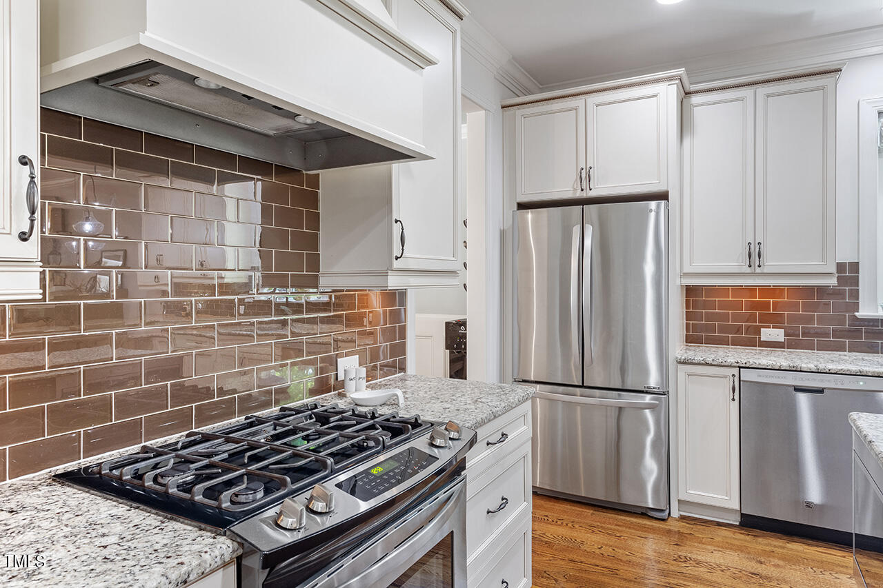2016 Brassfield Road Raleigh, NC 27614 - Photo 8 of 44 a kitchen with wooden cabinets and a stove top oven
