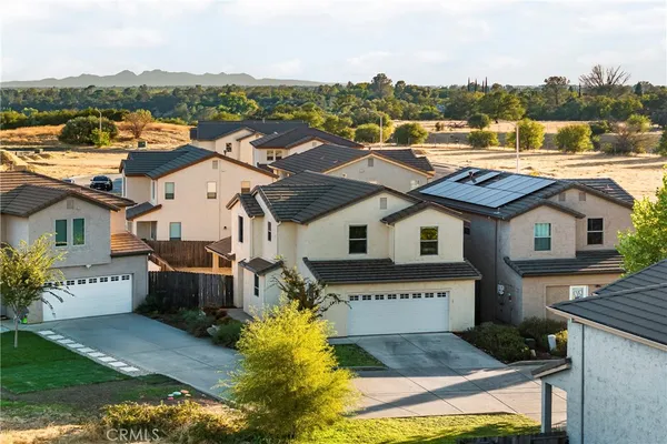 an aerial view of a house with a big yard and large trees