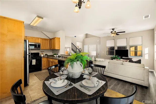 a living room with furniture a dining table and kitchen view
