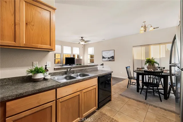 a kitchen with granite countertop a sink and cabinets