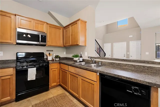 a kitchen with stainless steel appliances granite countertop a sink stove and microwave