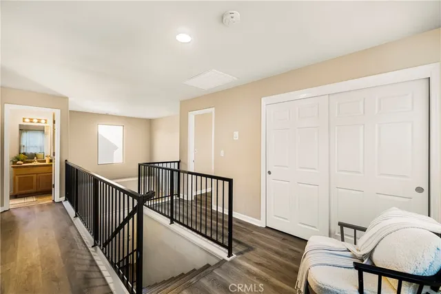 a view of a hallway with furniture and windows