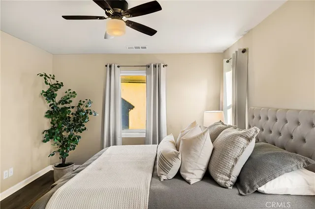 a bedroom with a bed and a potted plant