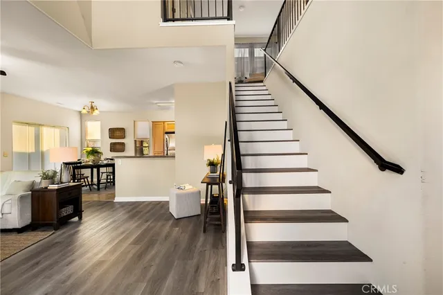 a view of entryway and hall with wooden floor