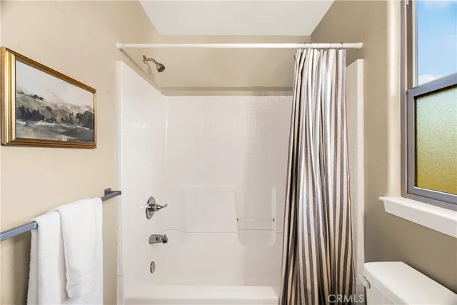 a bathroom with a shower and a tub