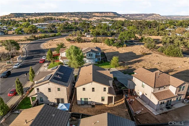 an aerial view of a house with a mountain