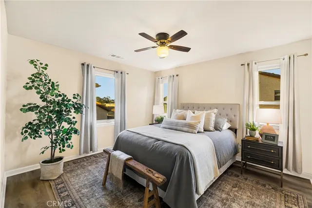 a bedroom with a bed and a potted plant