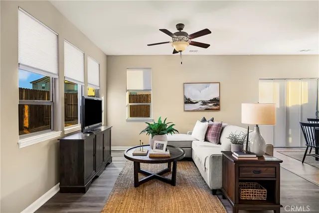 a living room with furniture a chandelier and a window
