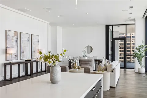 a living room with furniture and large windows