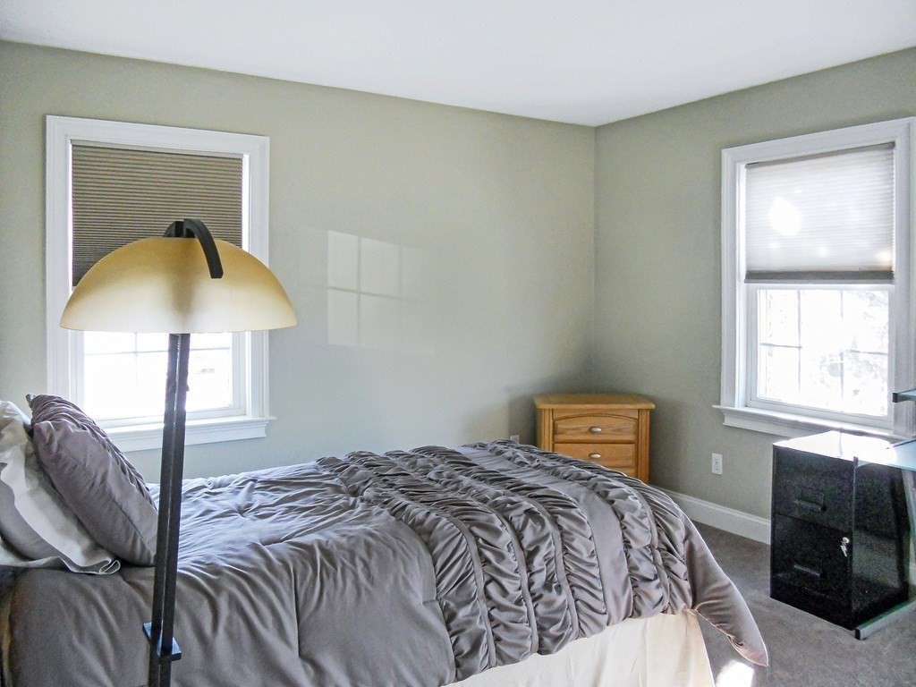 171 North Main Street, Unit 171 Natick, MA 01760 - Photo 12 of 15 a bedroom with a bed and a lamp