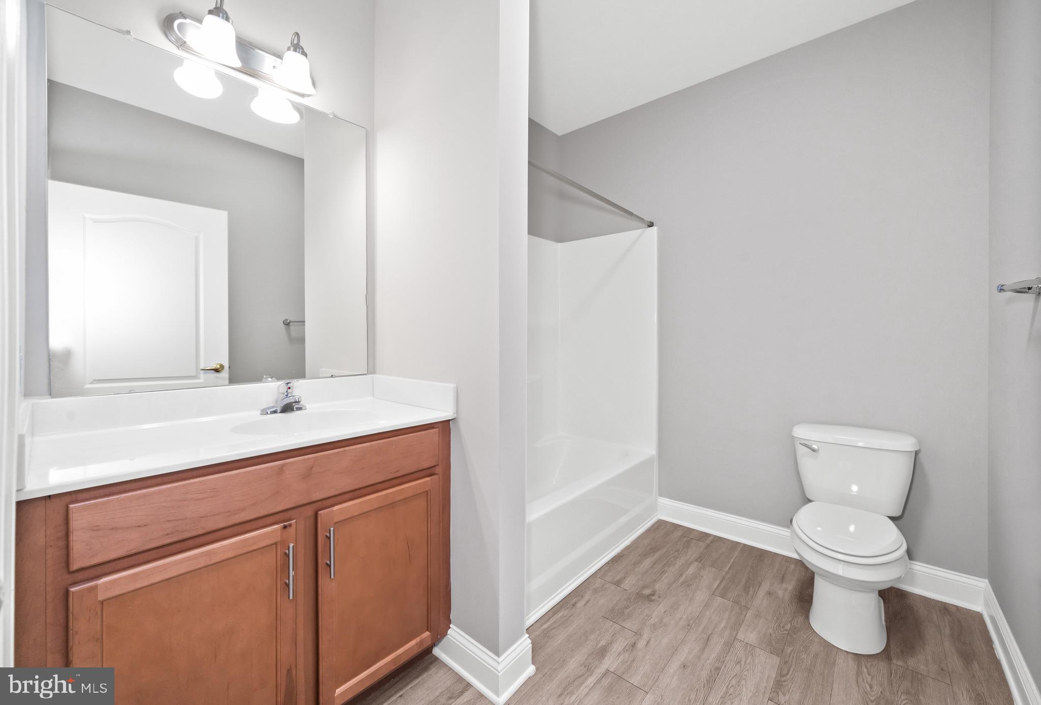 2000 Fountainview Circle, Unit 2312 Newark, DE 19713 - Photo 11 of 15 a bathroom with a toilet sink and mirror