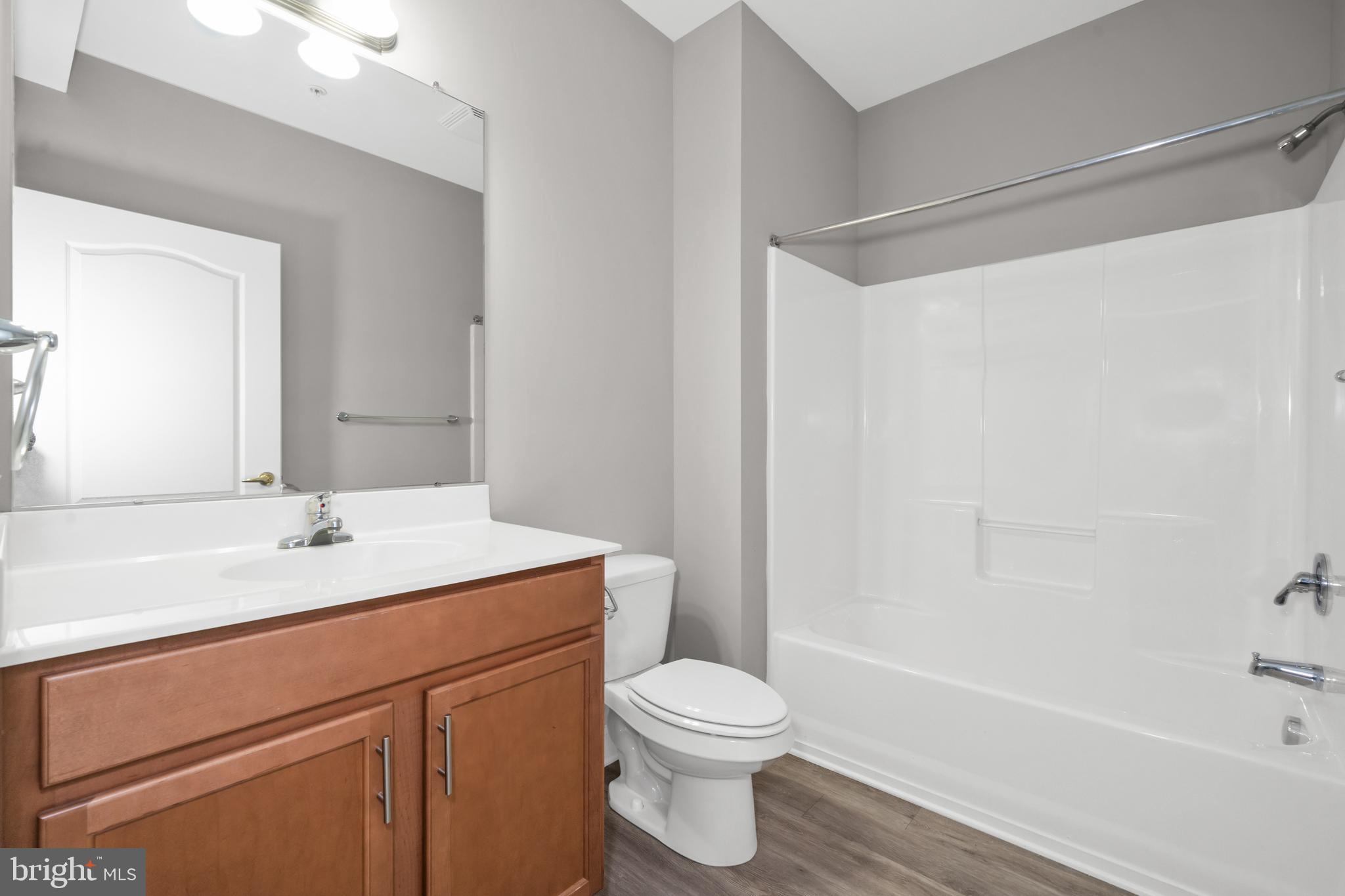 2000 Fountainview Circle, Unit 2312 Newark, DE 19713 - Photo 15 of 15 a bathroom with a sink a toilet and shower