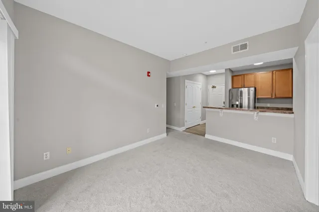 a view of a kitchen with a refrigerator and a sink