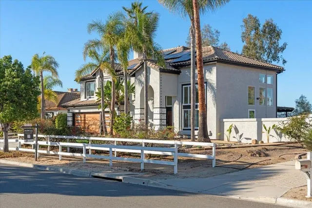 a front view of a house with swimming pool and sitting area