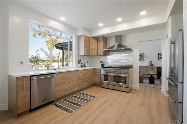 a kitchen with stainless steel appliances kitchen island granite countertop a stove and a sink