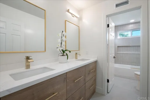 a bathroom with a bathtub a toilet and a shower