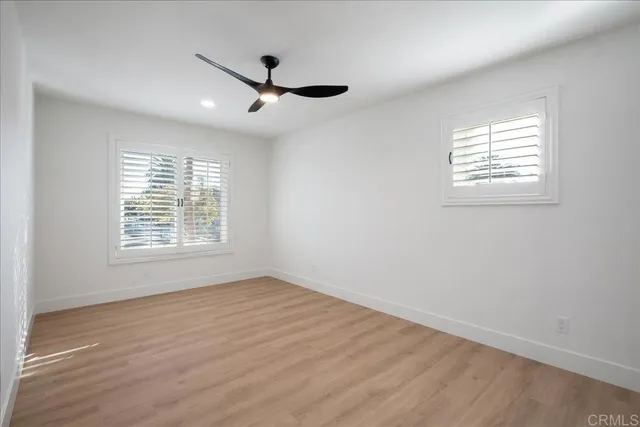 a spacious bathroom with a tub a potted plant and a sink
