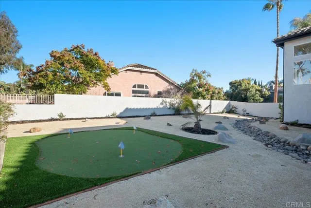 a view of a house with pool and a yard